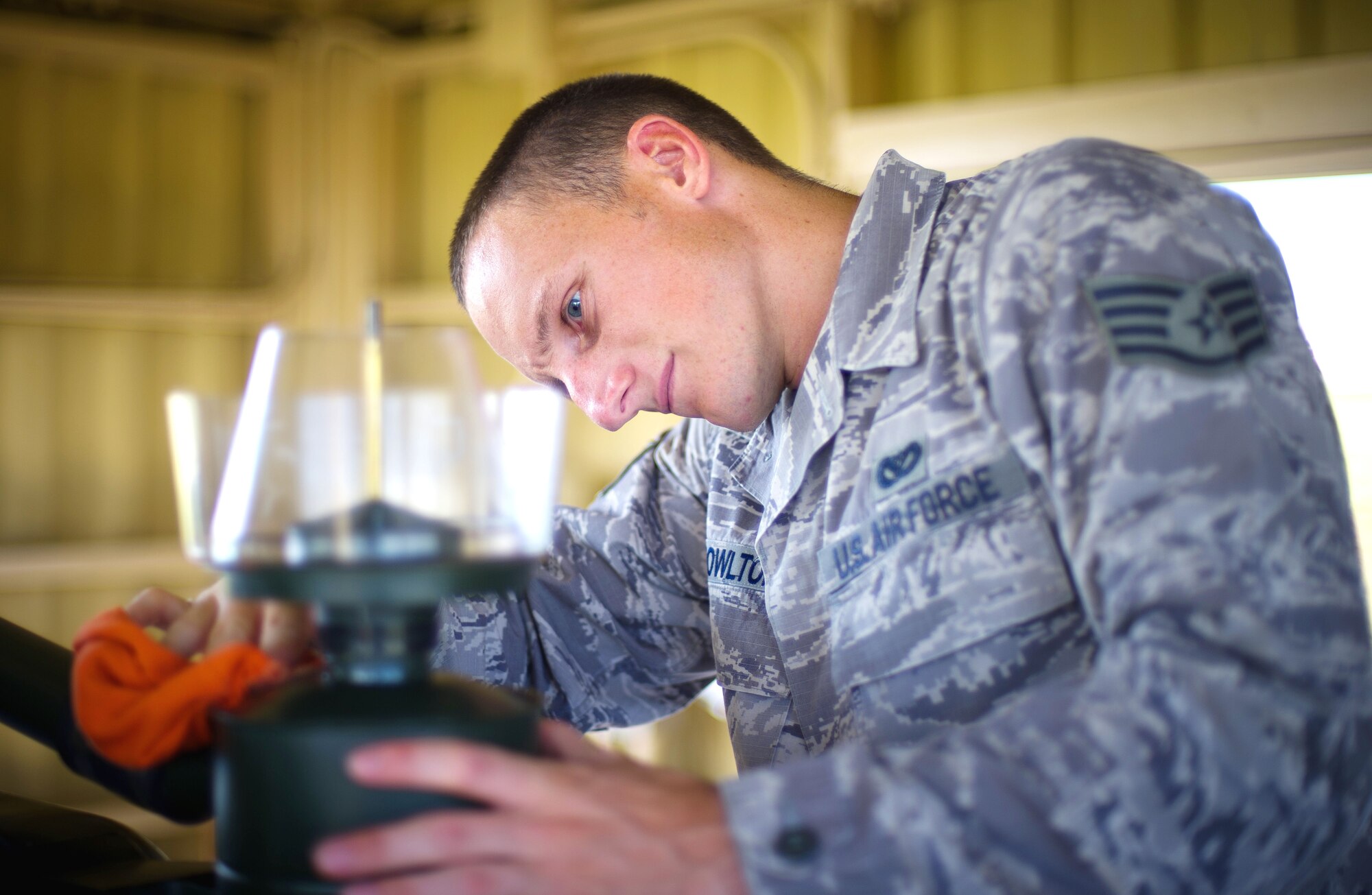 YOKOTA AIR BASE, Japan -- Staff Sgt. Daniel Knowlton, 374th Civil Engineer Squadron electrical power productions technician, inspects a BAK-12 aircraft arresting system for hydraulic fluid leaks at Yokota Air Base, Japan, on Sept. 5, 2012. The BAK-12 is used for tightening the emergency aircraft cable if a fighter jet had to land at Yokota. (U.S. Air Force photo by Staff Sgt. Chad C. Strohmeyer)