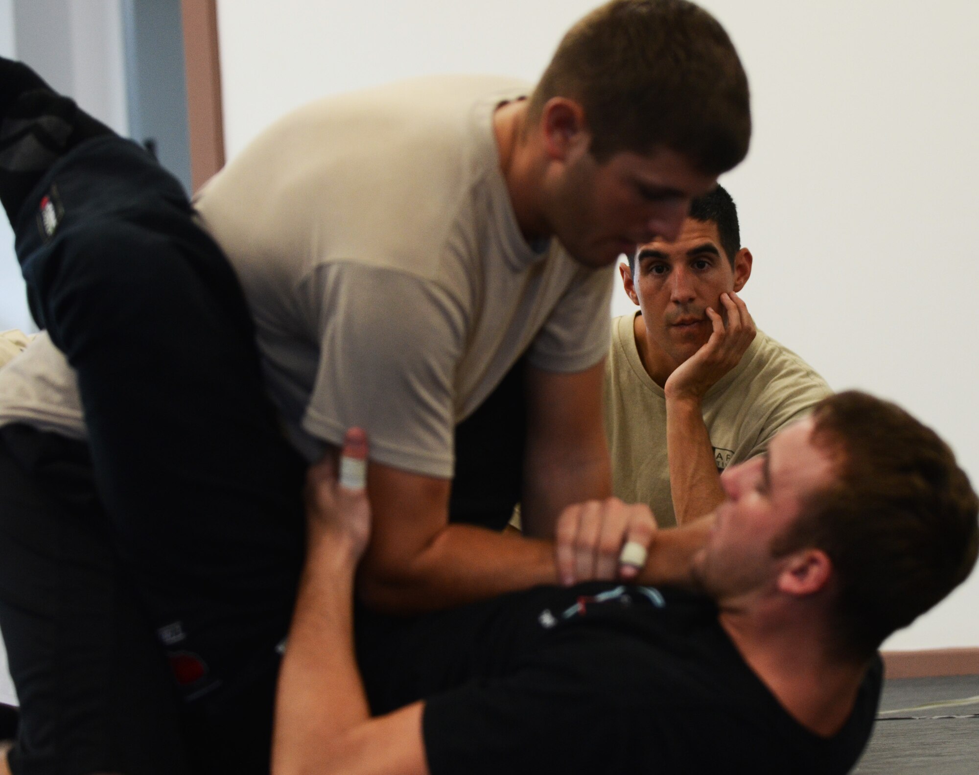 FORT JUAN MUNA, Guam—Capt. Nathaniel Lesher, 736th Security Force Squadron pacific region training center officer in charge, evaluates students during the tested portion of the Air Force combative course, Aug. 30. Students had to demonstrate proper technique and knowledge of the curriculum before graduating the combative course.  (U.S. Air Force photo by Senior Airman Benjamin Wiseman/Released)