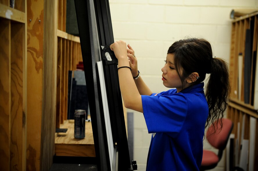 Yui Makawa, a Kadena Language Institute student, cuts out matting for a frame at Crafty Things on Kadena Air Base, Japan, Sept. 04, 2012. Makawa is working at the frame works section as part of the KLI internship program in order to practice English conversation skills and English business styles. (U.S. Air Force photo/Airman 1st Class Brooke P. Beers)