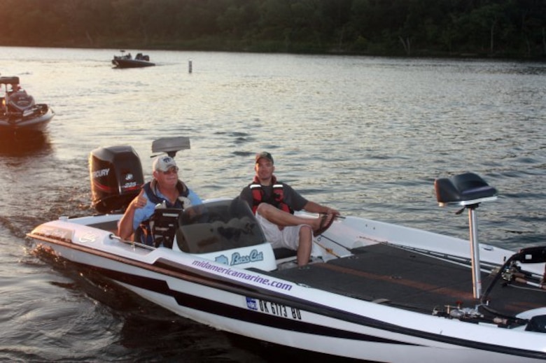 Airman winner Staff Sgt. Jon Brennan and his American Bass Anglers boater Jim Clay passing by the boat ramp for inspection before heading out onto Big Hill Lake in southeastern Kansas for the "Take an Airman" fishing day July 21.