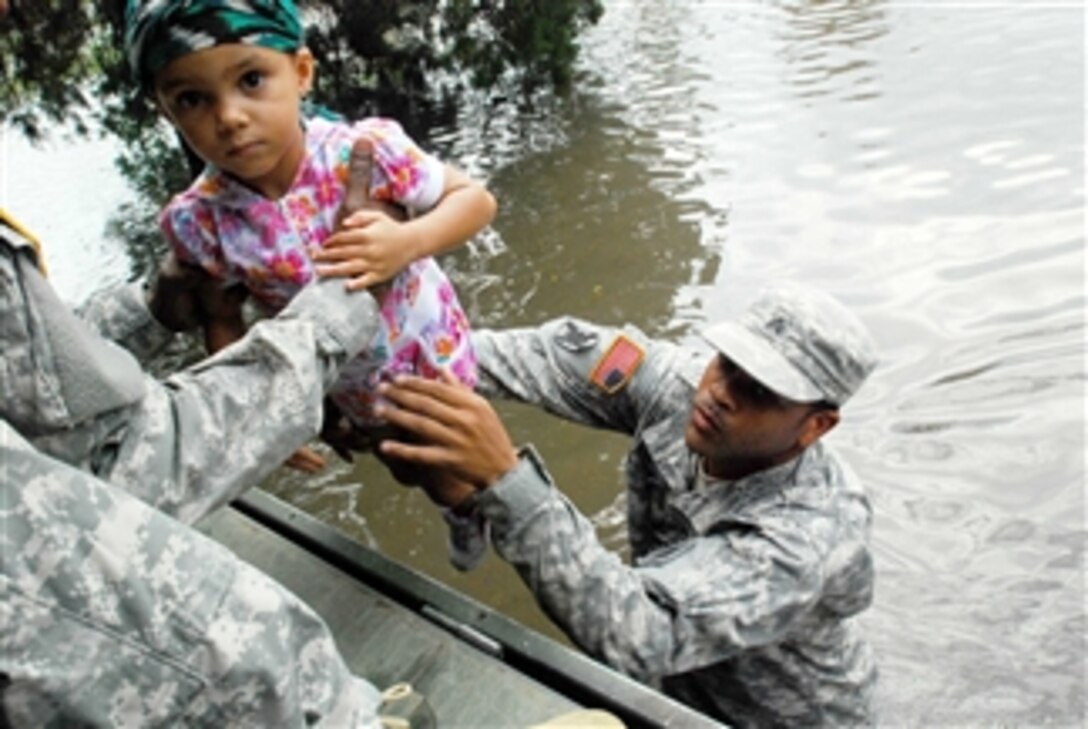U.S. Army Sgt. Lee Savoy lifts a child into a boat for evacuation from a flood caused by Hurricane Isaac in La Place, La., on Aug. 30, 2012.  Savoy is attached to the 256th Brigade Special Troops Battalion, Louisiana Army National Guard.  Isaac developed as a tropical storm over the Western Atlantic Ocean affecting Puerto Rico, the Dominican Republic, Haiti and Cuba before making landfall as a hurricane on the Gulf Coast of the United States.  