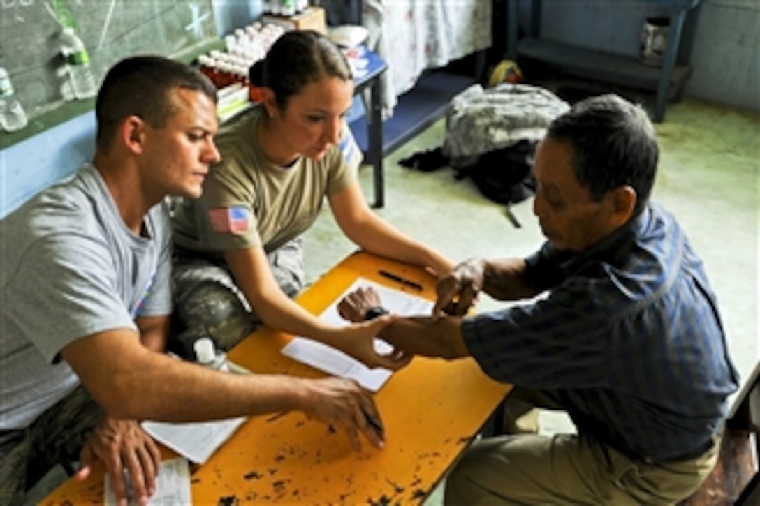 U.S. Air Force Senior Airman Maria Abello listens to a Costa Rican patient explain his ailments as she prepares to translate for Air Force Staff Sgt. Michael Canfield during a joint medical readiness training exercise in Costa Rica, Aug. 29, 2012. Together with Costa Rica’s Ministry of Health and Social Services, service members assigned to Joint Task Force Bravo delivered medical care to 704 patients in the Costa Rican villages of San Juan and Damitas.