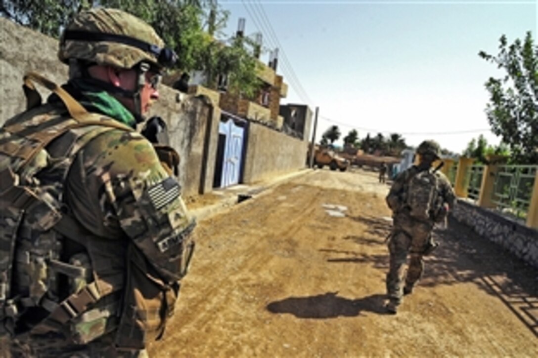U.S. Army Sgt. Matthew Armstrong, left, provides security during a key leader engagement in Farah City in Afghanistan's Farah province, Aug. 29, 2012. Armstrong is assigned to Provincial Reconstruction Team Farah.