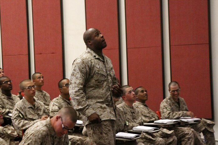 Staff Sgt. Van Black, academic instructor, Instructional Training Company, Support Battalion, teaches rules Marines must follow in combat to recruits of Co. G, 2nd Recruit Training Battalion aboard Marine Corps Recruit Depot San Diego, Aug. 27. Black taught the Law of Land Warefare class with the aide of a slideshow and a short movie clip. Black reviewed the material with recruits by asking them questions based off of the rules they learned. 