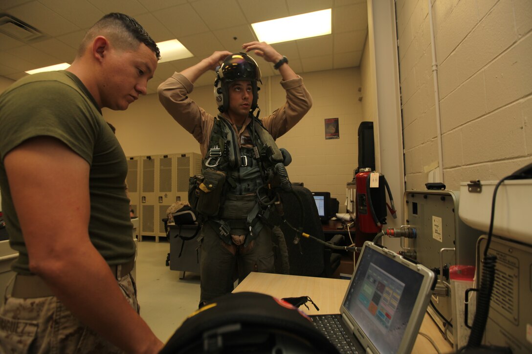 Lance Cpl. Walter Rodriguez, a Marine All-Weather Fighter Attack Squadron 224 flight equipment technician, inspects the flight vest during routine maintenance at the the flight equipment section aboard the Air Station,
Aug. 21.