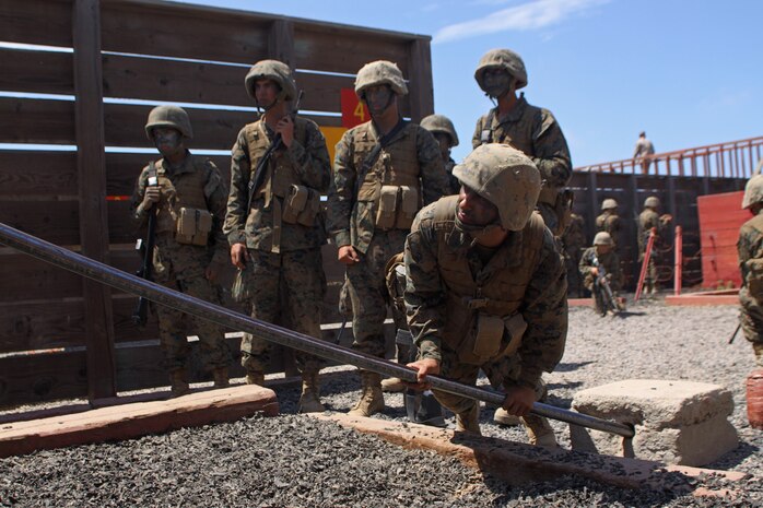 Recruit John M. Lemus, squad leader, Platoon 2105, Co. E, 2nd Recruit Training Battalion, tests the stability of a pole before allowing fellow recruits to start an exercise during the crucible aboard Marine Corps Base Camp Pendleton, Calif. Lemus is a 26-year-old squad leader who plans to make the Marine Corps a 20-year career.