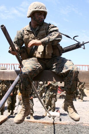 Recruit John M. Lemus, squad leader, Platoon 2105, Co. E, 2nd Recruit Training Battalion, works himself through an exercise during the crucible aboard Marine Corps Base Camp Pendleton, Calif. Lemus has a bachelors degree in business economics and plans to become an officer through the Marine Enlisted Commissioning Education Program.  