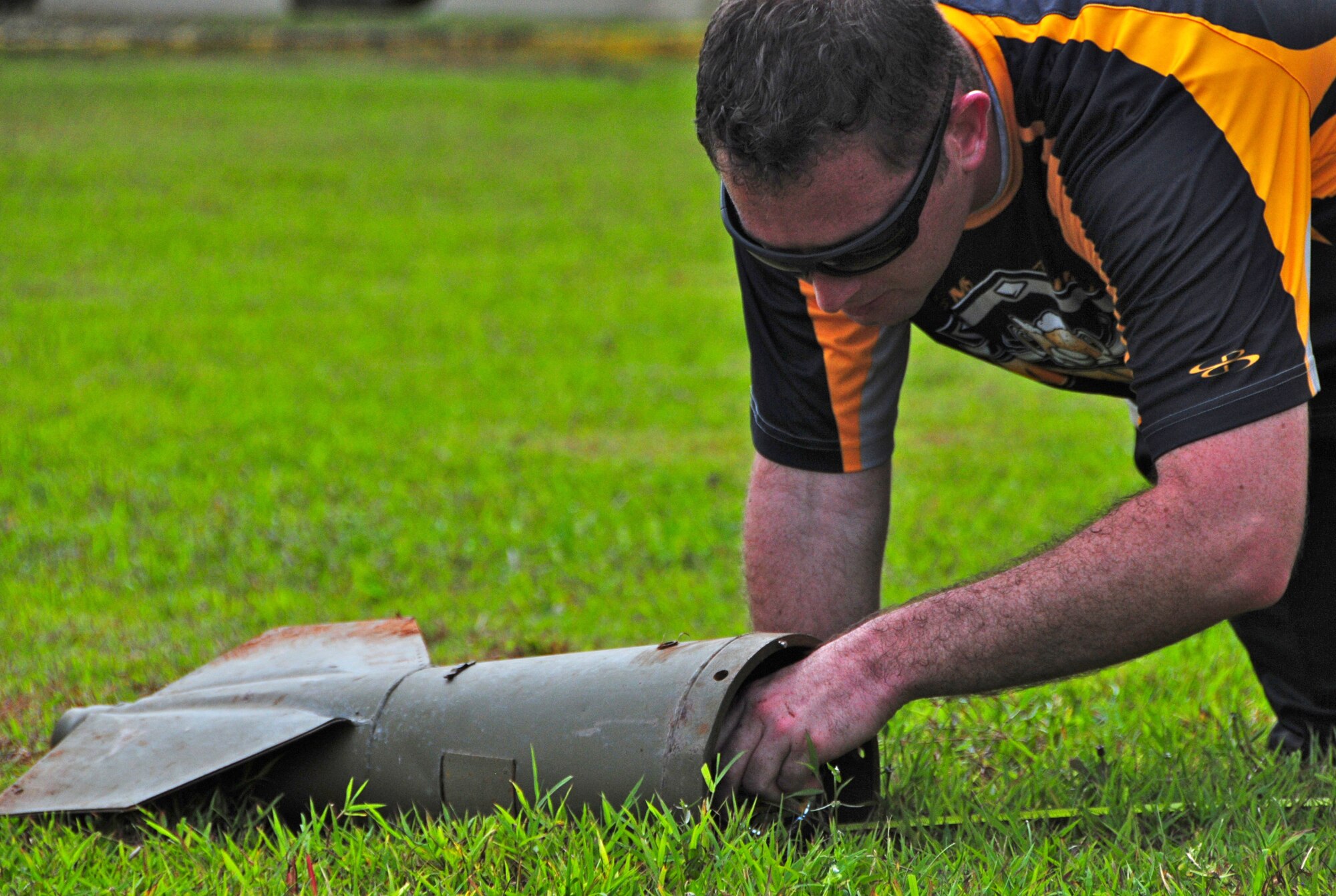 ANDERSEN AIR FORCE BASE, Guam -- Staff Sgt. Erick Cole, 36th Munitions Squadron munitions inspector, measures how far an Airman tossed a fin during the Ammo Olympics here, Aug. 30. The Ammo Olympics is an annual event where the Airmen of 36th Munitions Squadron build teams and compete with each other in events that test the Airmen’s strength, teamwork and ingenuity. (U.S. Air Force photo by Airman 1st Class Marianique Santos/Released)