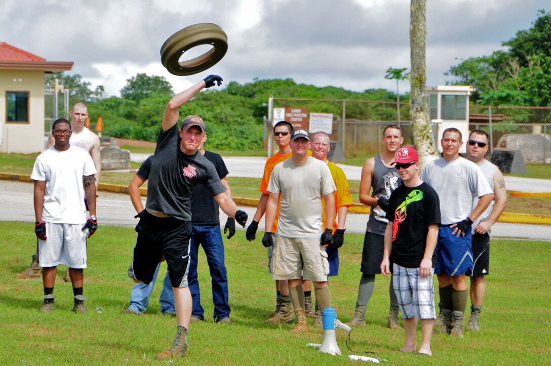 ANDERSEN AIR FORCE BASE, Guam -- Airman 1st Class Cody O’Donnell, 36th Munitions Squadron storage crew member, tosses a butt plate during the Ammo Olympics here, Aug. 30. The Ammo Olympics is an annual event where the Airmen of 36th Munitions Squadron build teams and compete with each other in events that test the Airmen’s strength, teamwork and ingenuity. (U.S. Air Force photo by Airman 1st Class Marianique Santos/Released)