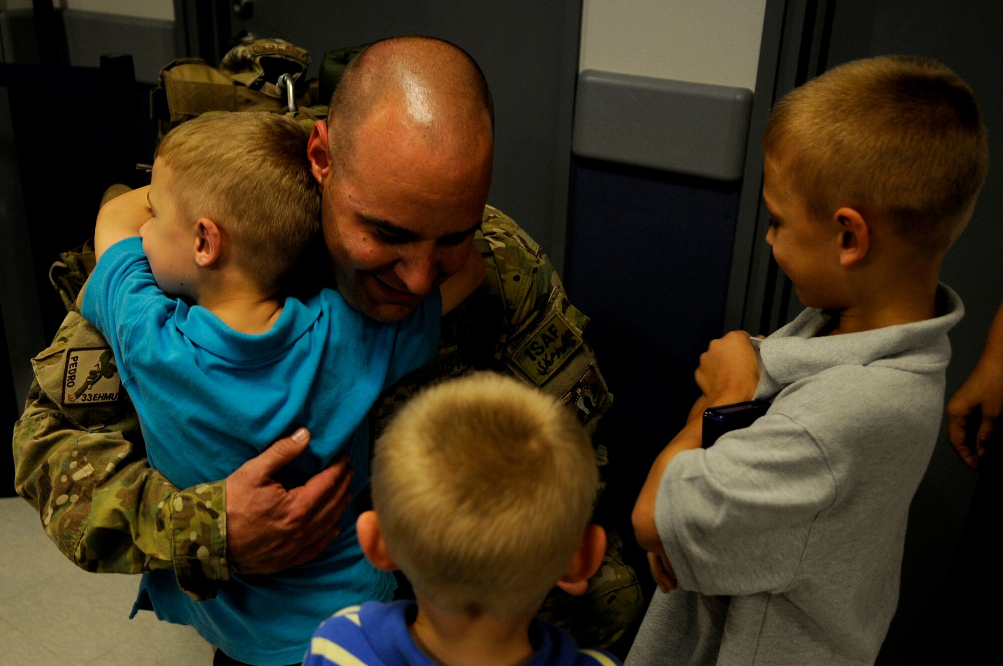 U.S. Air Force Senior Master Sgt. Tim DeBeaux, 718th Aircraft Maintenance Squadron sortie generation superintendent, is greeted by his three boys during the 718th AMXS and 33rd Rescue Squadron redeployment on Kadena Air Base, Japan, Sept. 6, 2012. Members from the 718th AMXS and 33rd RQS returned to Kadena after their roughly four-month deployment in support of operations and contingencies in Afghanistan since May. (U.S. Air Force photo/Airman 1st Class Tara A. Williamson)