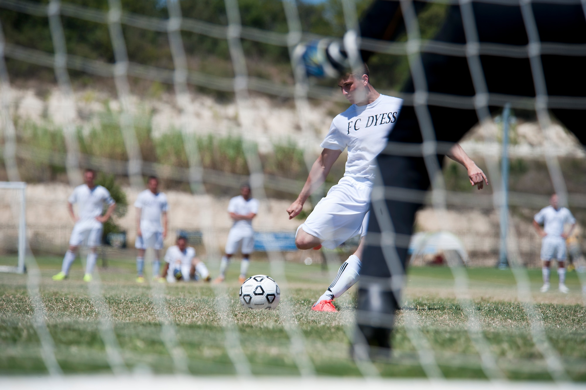 Dyess forward Blake Hill takes a penalty kick Sept. 2, 2012, during the Defender’s Cup at San Antonio. During the first day of the tournament, teams were placed into groups of four and played each other to see where they would be placed in the tournament’s bracket. Team Dyess went undefeated during the group portion, beating Team Hill, Columbus and Medina. This placed them No. 1 in their group and fifth overall in the 22-team competition. Having the top seed in their group gave Dyess a first-round bye on the second day of the tournament, where they faced Luke AFB. In a tough game, Luke defeated Dyess in penalty kicks after tying 1-1 during regulation. (U.S. Air Force photo by Airman 1st Class Damon Kasberg/Released)