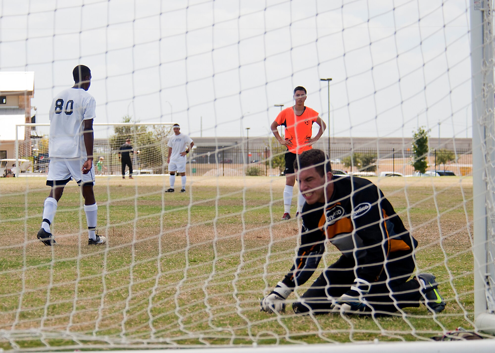 Luke goalkeeper Alex Balok reacts after Dyess Football Club forward Gerald Hodges scores Sept. 2, 2012, during the Defender’s Cup at San Antonio. During the first day of the tournament, teams were placed into groups of four and played each other to see where they would be placed in the tournament’s bracket. Team Dyess went undefeated during the group portion, beating Team Hill, Columbus and Medina. This placed them No. 1 in their group and fifth overall in the 22-team competition. Having the top seed in their group gave Dyess a first-round bye on the second day of the tournament, where they faced Luke AFB. In a tough game, Luke defeated Dyess in penalty kicks after tying 1-1 during regulation. (U.S. Air Force photo by Airman 1st Class Damon Kasberg/Released)