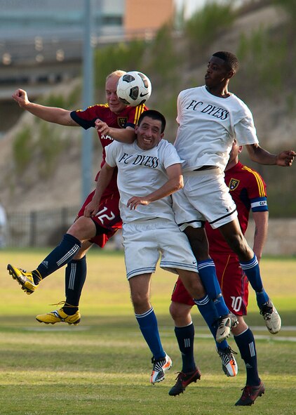 Dyess defensive midfielder Celio Puga, left, and forward Gerald Hodges, right, jump for the ball Sept. 1, 2012, during the Defender’s Cup at San Antonio. During the first day of the tournament, teams were placed into groups of four and played each other to see where they would be placed in the tournament’s bracket. Team Dyess went undefeated during the group portion, beating Team Hill, Columbus and Medina. This placed them No. 1 in their group and fifth overall in the 22-team competition. Having the top seed in their group gave Dyess a first-round bye on the second day of the tournament, where they faced Luke AFB. In a tough game, Luke defeated Dyess in penalty kicks after tying 1-1 during regulation. (U.S. Air Force photo by Airman 1st Class Damon Kasberg/Released)