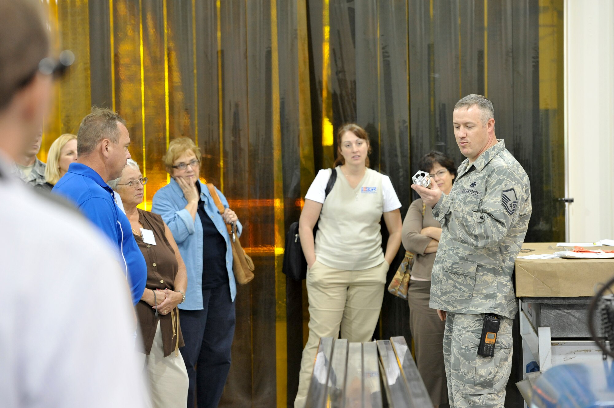 YOUNGSTOWN AIR RESERVE STATION, Ohio—Master Sgt. Jason Cox, a member of the 445th Maintenance Squadron Fabrication Flight, displays parts manufactured by his shop and discusses the aircraft part fabrication process with a group of civilian employers during an ESGR funded Boss Lift from Youngstown Air Reserve Station to Wright-Patterson Air Force Base, both in Ohio. ESGR Boss Lifts are intended to provide employers the opportunity to experience and observe the work and mission of Guard and Reserve forces, building advocacy for Reservists and Guardsmen who deploy or require time away from civilian jobs for military duty. Employers are transported, via military aircraft or watercraft, to military facilities where they observe Guard and Reserve members on duty. The 445th Fabrication Flight, which is responsible for aircraft structural maintenance, was selected as the 2011 Air Force Reserve Command maintenance Section of the Year. U.S. Air Force photo by Mr. Eric M. White