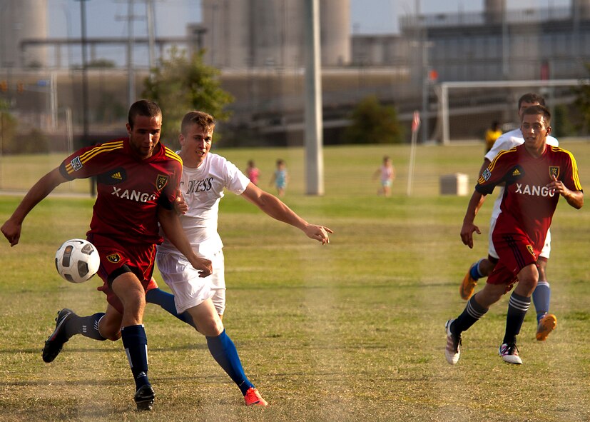 Dyess forward Blake Hill attempts to get past an opponent Sept. 1, 2012, during the Defender’s Cup at San Antonio. During the first day of the tournament, teams were placed into groups of four and played each other to see where they would be placed in the tournament’s bracket. Team Dyess went undefeated during the group portion, beating Team Hill, Columbus and Medina. This placed them No. 1 in their group and fifth overall in the 22-team competition. Having the top seed in their group gave Dyess a first-round bye on the second day of the tournament, where they faced Luke AFB. In a tough game, Luke defeated Dyess in penalty kicks after tying 1-1 during regulation. (U.S. Air Force photo by Airman 1st Class Damon Kasberg/Released)