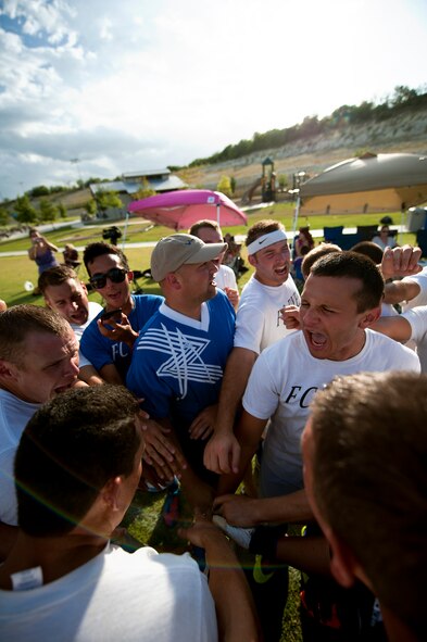Members of the Dyess Football Club get pumped up after a rough half Sept. 1, 2012, during the Defender’s Cup at San Antonio. During the first day of the tournament, teams were placed into groups of four and played each other to see where they would be placed in the tournament’s bracket. Team Dyess went undefeated during the group portion of the tournament, beating Team Hill, Columbus and Medina. This placed them No. 1 in their group and fifth overall in the 22-team tournament. Having the top seed in their group gave Dyess a first-round bye on the second day of the tournament, where they faced Luke AFB. In a tough game, Luke defeated Dyess in penalty kicks after tying 1-1 during regulation. (U.S. Air Force photo by Airman 1st Class Damon Kasberg/Released)