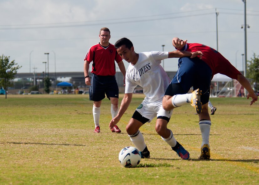 Dyess winger Jose Jimenez bypasses an opponent Sept. 1, 2012, during the Defender’s Cup at San Antonio. During the first day of the tournament, teams were placed into groups of four and played each other to see where they would be placed in the tournament’s bracket. Team Dyess went undefeated during the group portion, beating Team Hill, Columbus and Medina. This placed them No. 1 in their group and fifth overall in the 22-team competition. Having the top seed in their group gave Dyess a first-round bye on the second day of the tournament, where they faced Luke AFB. In a tough game, Luke defeated Dyess in penalty kicks after tying 1-1 during regulation. (U.S. Air Force photo by Airman 1st Class Damon Kasberg/Released)