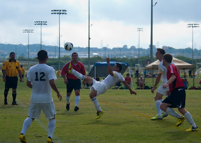 Dyess attacking midfielder Jose Macias bicycle kicks the ball Sept. 1, 2012, during the Defender’s Cup at San Antonio. During the first day of the tournament, teams were placed into groups of four and played each other to see where they would be placed in the tournament’s bracket. Team Dyess went undefeated during the group portion, beating Team Hill, Columbus and Medina. This placed them No. 1 in their group and fifth overall in the 22-team competition. Having the top seed in their group gave Dyess a first-round bye on the second day of the tournament, where they faced Luke AFB. In a tough game, Luke defeated Dyess in penalty kicks after tying 1-1 during regulation. (U.S. Air Force photo by Airman 1st Class Damon Kasberg/Released)