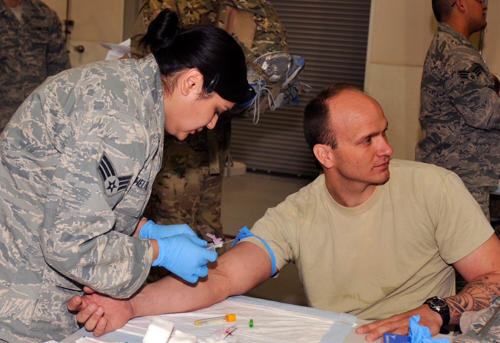 A medical technician draws blood from a returning service member during Operation Homecoming at Cannon Air Force Base, N.M., Sept. 5, 2012. Operation Homecoming is a monthly event held to welcome Air Commandos back from worldwide deployments and reunite them with family and friends. (U.S. Air Force photo/Airman 1st Class Ericka Engblom)