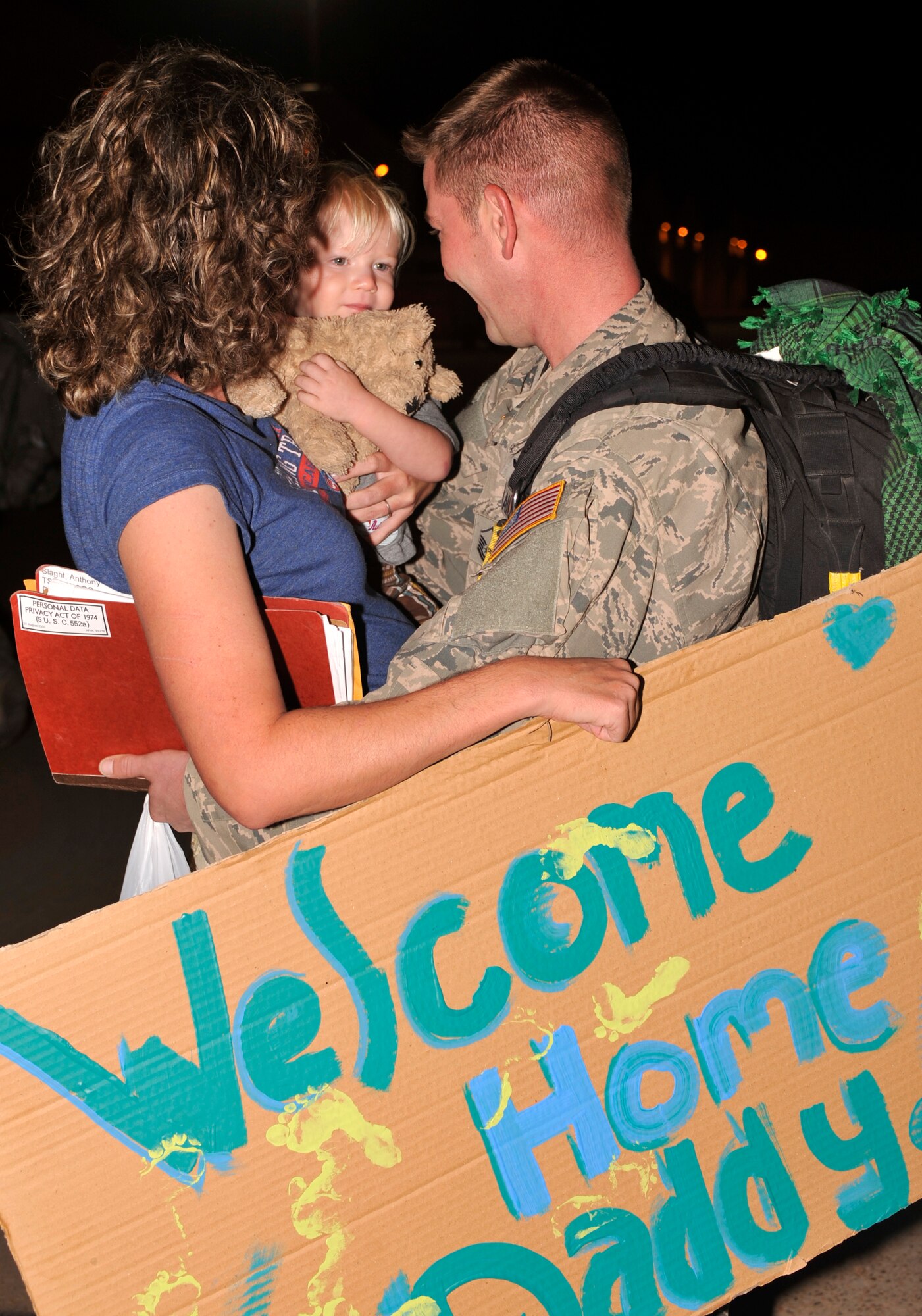 A member of the 16th Special Operations Squadron reunites with his family during Operation Homecoming at Cannon Air Force Base, N.M., Sept. 5, 2012. Operation Homecoming is a monthly event held to welcome Air Commandos back from worldwide deployments and reunite them with family and friends. (U.S. Air Force photo/Airman 1st Class Ericka Engblom)