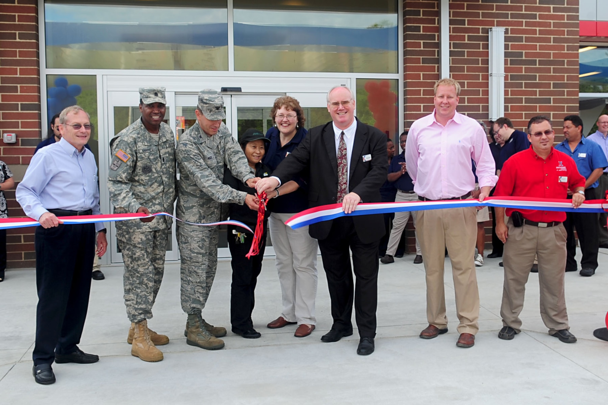 From left, David K. Morrow, 733rd Mission Support Group deputy commander, 733rd MSG Command Sgt. Maj. Jesse Sharpe, U.S. Air Force Col. Korvin Auch, 633rd Air Base Wing commander, Brenda Neilson, Army and Air Force Exchange store manager, and Wayne Hansen, AAFES general manager, cut the ribbon during the Exchange Express Station grand opening ceremony at Fort Eustis, Va., Sept. 6, 2012. Total construction cost $3.4 million and took only 10 months to complete. (U.S. Air Force photo by Staff Sgt. Ashley Hawkins/Released)