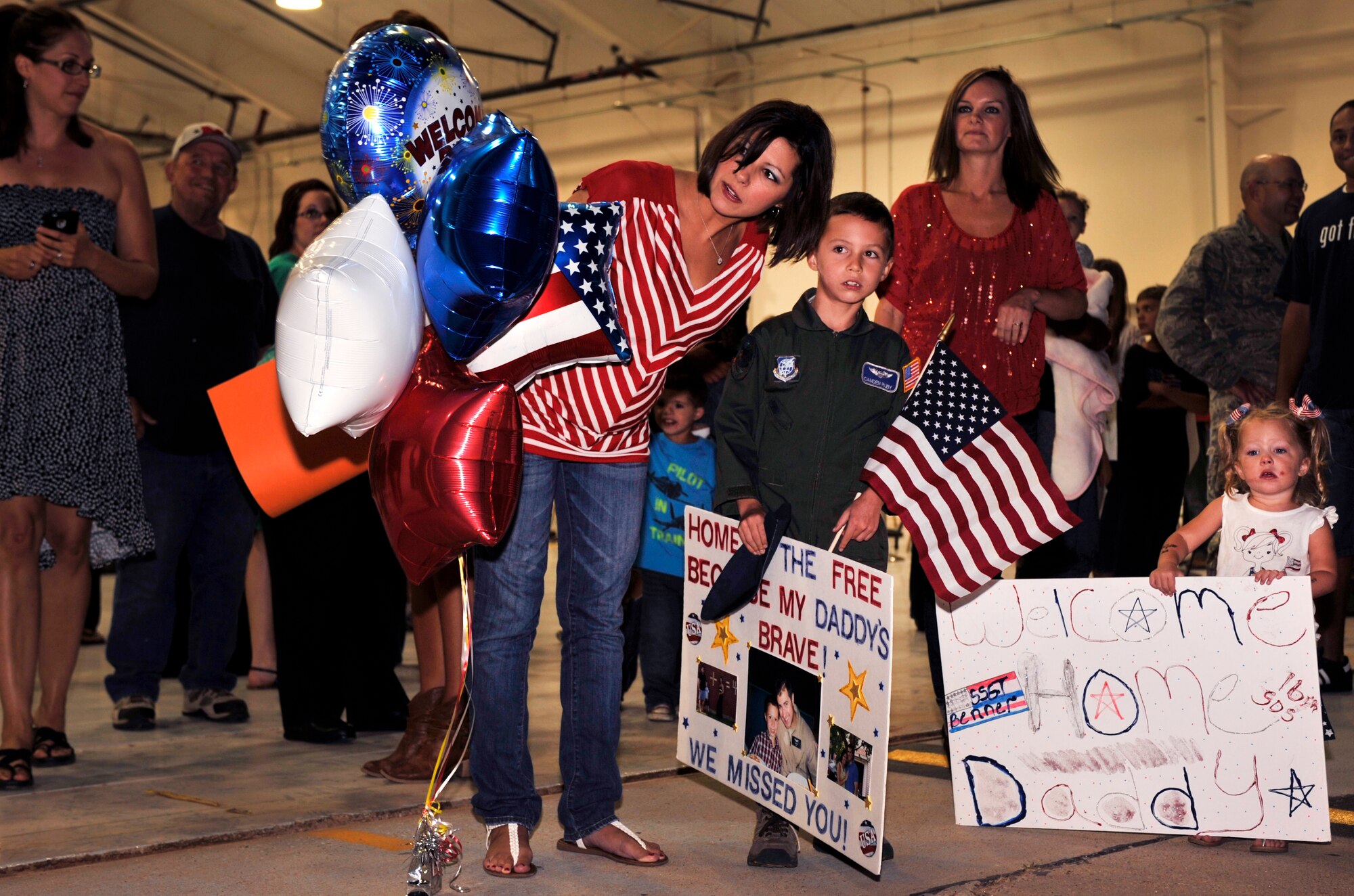 Families await the arrival of their loved ones during Operation Homecoming at Cannon Air Force Base, N.M., Sept. 5, 2012. Operation Homecoming is a monthly event held to welcome Air Commandos back from worldwide deployments and reunite them with family and friends. (U.S. Air Force photo/Airman 1st Class Ericka Engblom)
