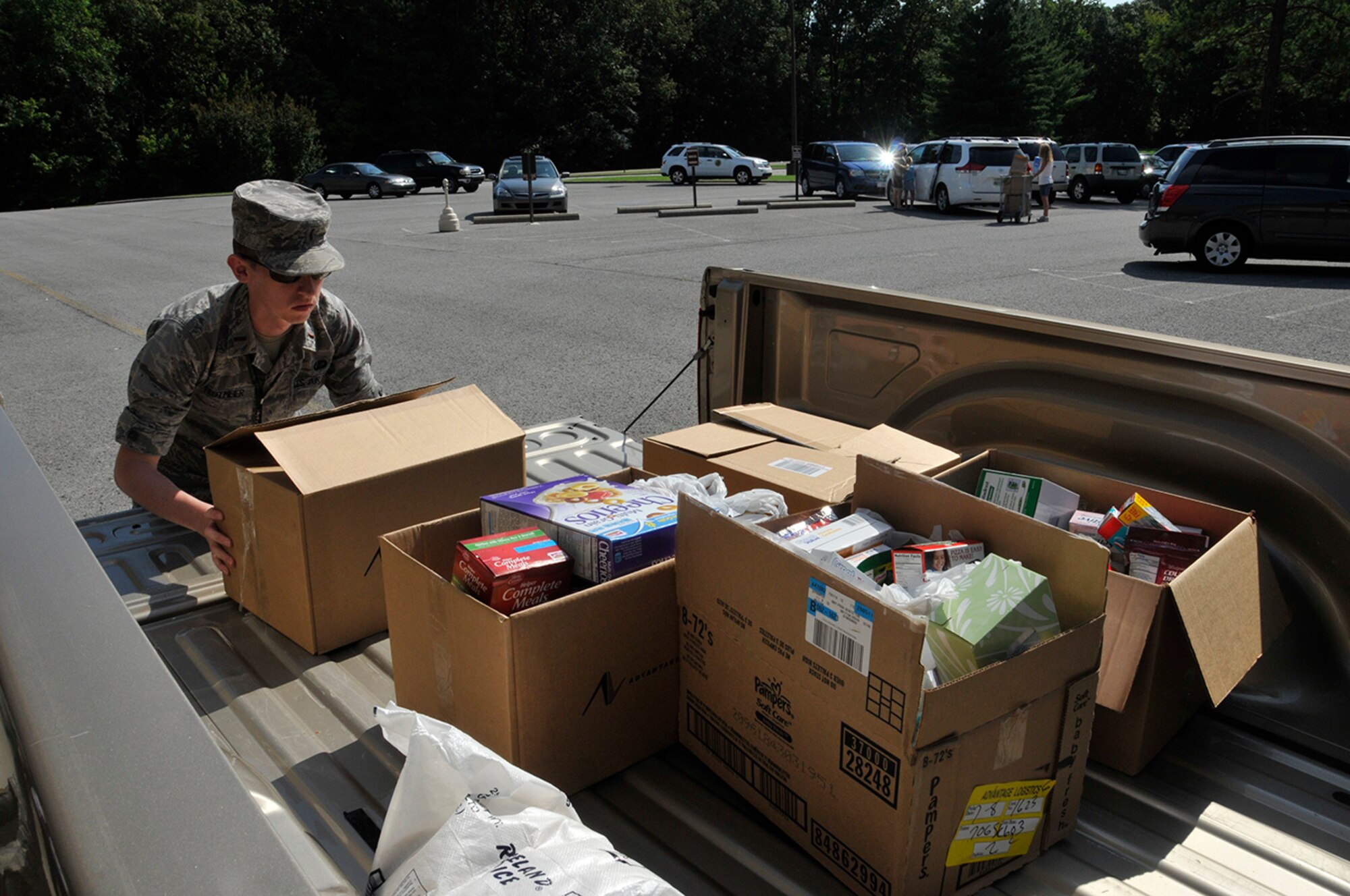 2nd Lt. Carl Tegtmeier, a Junior Force Council volunteer at AEDC, loads donated non-perishable food and hygiene items into his truck to deliver to one of several local Good Samaritan organizations participating in the annual Feds Feed Families food drive. (Photo by Rick Goodfriend)