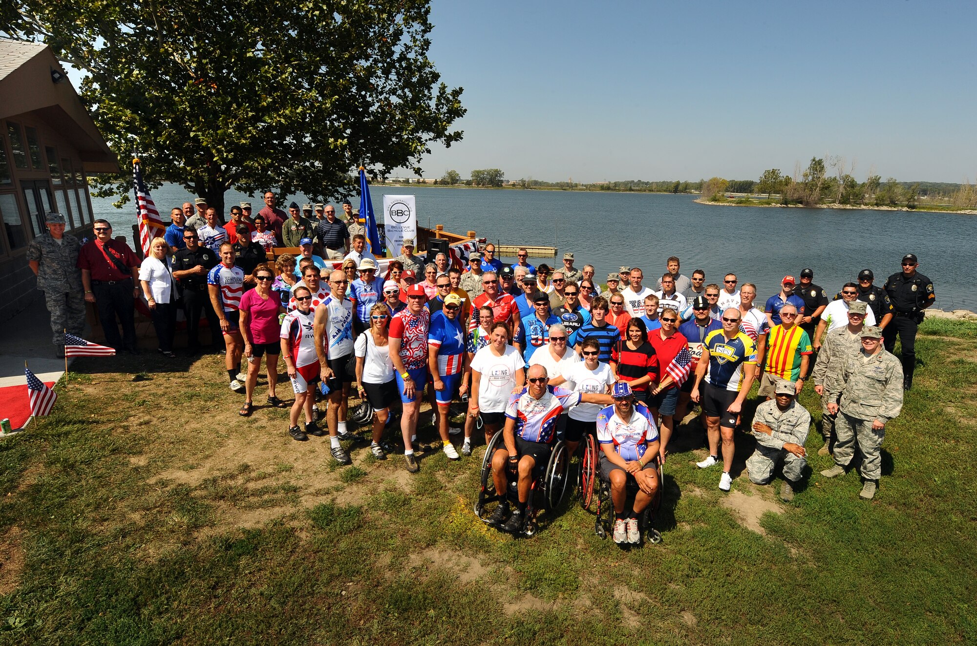 Five veteran cyclists associated with the Long Road Home fund raiser are accompanied by dozens of local area rider in support of their cause as they pose for a group photo following the formal festivities hosted by the Offutt Advisory Council at Offutt Air Force Base, Neb., Aug. 30.  The Long Road Home project consists of five, veteran cyclists that are riding from Tacoma Wash. to Washington D.C. over a ninety day period to raise awareness and funds concerning veterans’ affairs.  (U.S. Air Force photo by Josh Plueger/Released)