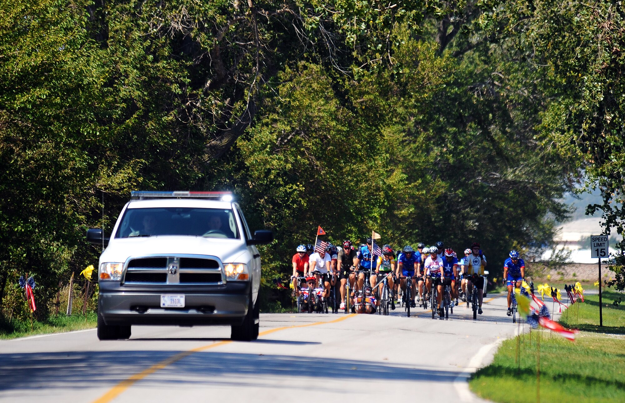 Five veteran cyclists associated with the Long Road Home fund raiser are accompanied by dozens of local area rider in support of their cause as they enter the Base Lake for formal festivities hosted by the Offutt Advisory Council and Offutt Air Force Base, Neb., Aug. 30.  The Long Road Home project consists of Veteran cyclists that are riding from Tacoma, Wash. to Washington D.C. over a ninety day period to raise awareness and funds concerning veterans’ affairs.  (U.S. Air Force photo by Josh Plueger/Released)