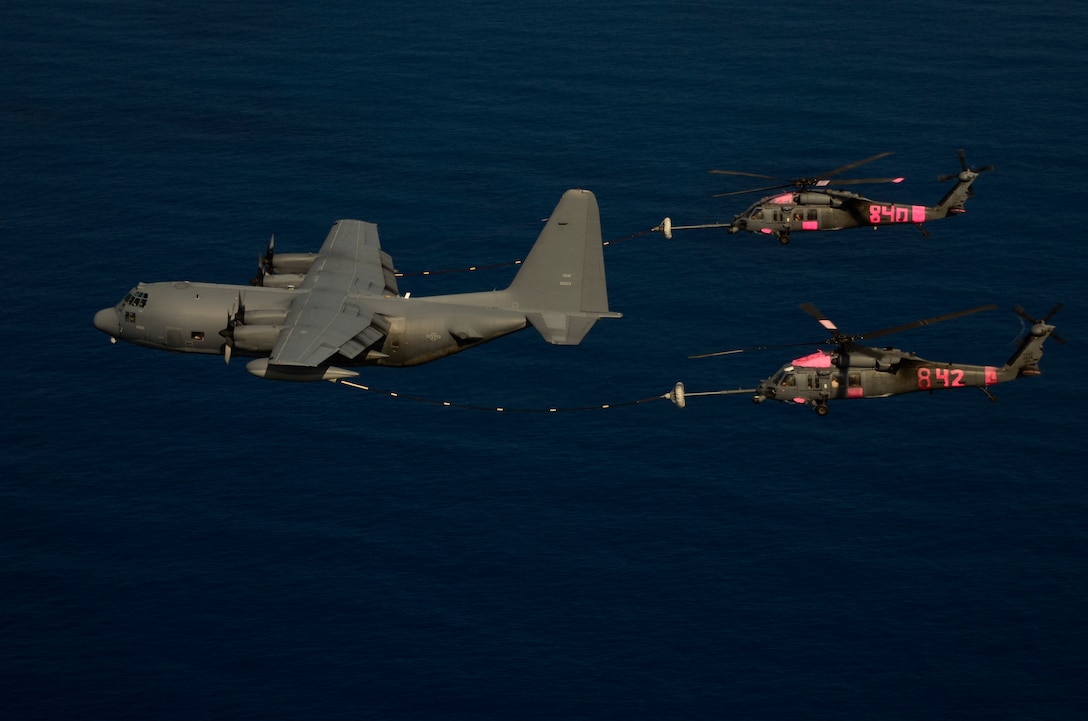 An MC-130P Combat Shadow airplane refuels two HH-60G Pave Hawk rescue helicopters, still marked pink from supporting Northern California wildfire operations last week, over the Pacific Ocean during a rescue mission on September 5, 2012.  The aircraft, all from the 129th Rescue Wing, were used in a joint operation with the U.S. Coast Guard to rescue two injured Ecuadorian fishermen. (Air National Guard photo by Airman 1st Class John D. Pharr III)