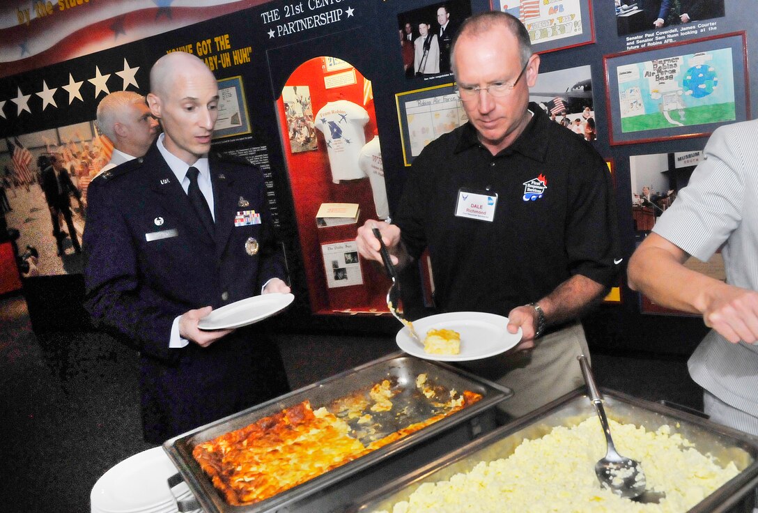 Col. Timothy Molnar,	402nd Aircraft Maintenance Group commander, goes through a breakfast buffet line with his new honorary commander, Dale Richmond, owner of First Response Service Inc. A ceremony was held at the Museum of Aviation Friday to induct new commanders into the Honorary Commanders Program program for the  2012-2013 term . The program began in 2005 and was exclusive to the Warner Robins Air Logistics Center. However, with the current restructure, the program is now targeted to Team Robins to include mission partners. It is designed to encourage an exchange of ideas, experiences, and friendship between key members of the local civilian community and members of Team Robins.  The program is a method to foster a supportive relationship between the base and the community, increase military involvement in civic endeavors and organizations and make the members of the local community part of the Robins AFB family (U. S. Air Force photo/Sue Sapp)