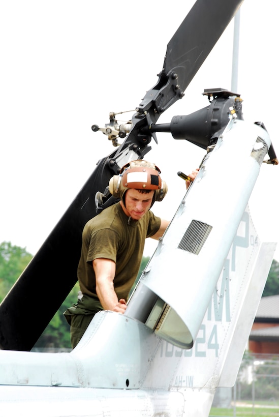 Lance Corporal Matthew Mills, helicopter mechanic, performs a daily inspection on an AH-1W Super Cobra attack helicopter tail rotor section. (U. S. Air Force photo/Ed Aspera Jr.) 