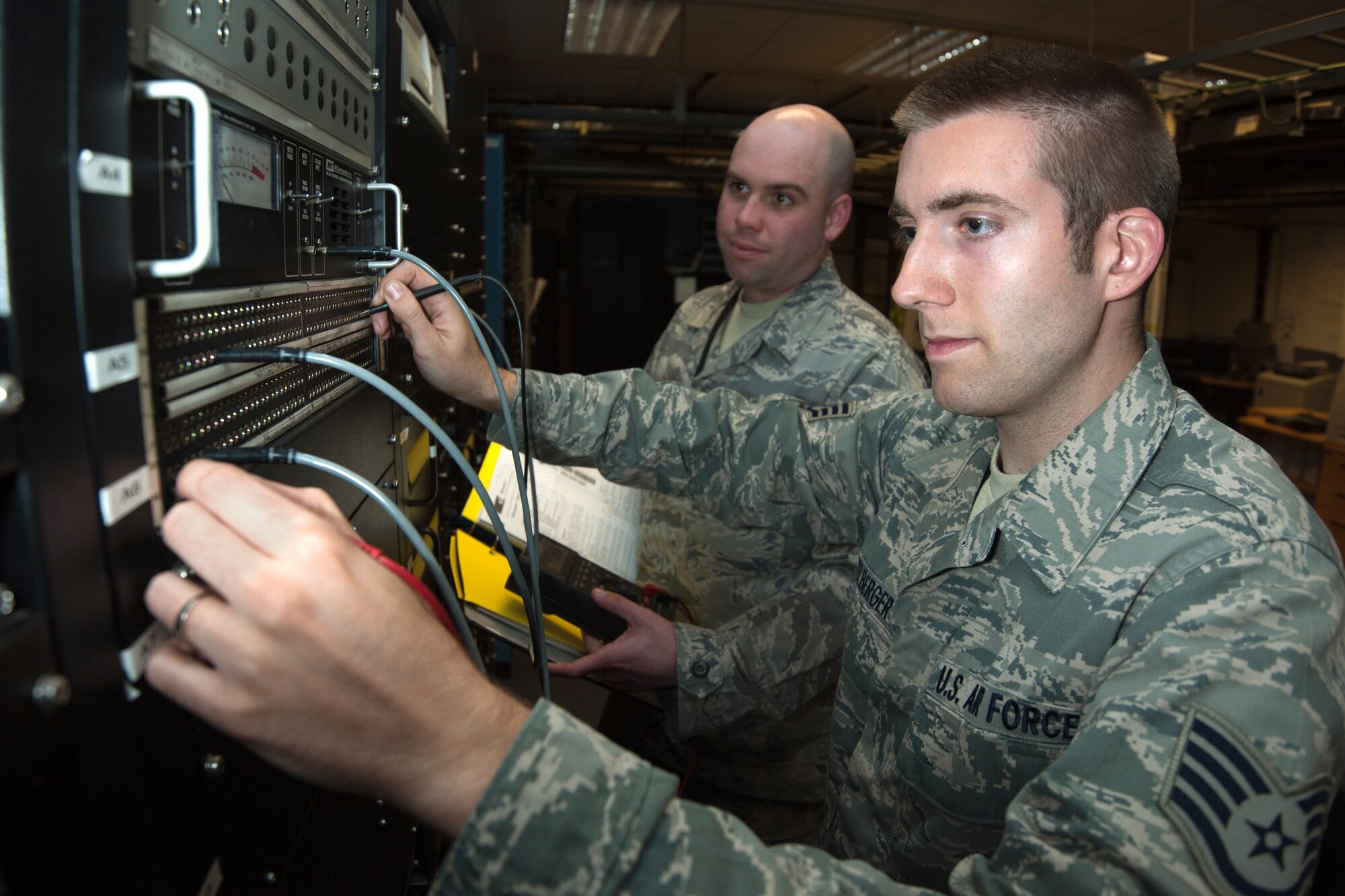 RAF CROUGHTON, United Kingdom – (Left) Staff Sgt. Raymond Parker, 422nd Communications Squadron high frequency systems NCOIC, and Walter Heidelberger, 422nd Communications Squadron high frequency systems supervisor, test a high frequency receiver patch panel at RAF Croughton Sept. 5. The 422nd CS provides global communications in support of U.S. and NATO objectives worldwide. (U.S. Air Force photo by Master Sgt. John Barton)