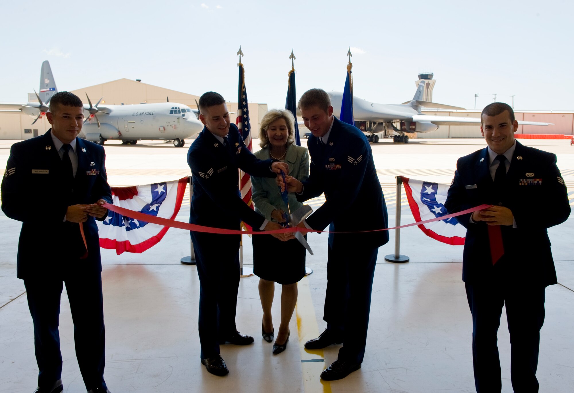 U.S. Sen. Kay Bailey Hutchison and Airmen from the 317th Airlift Group cut the ribbon Sept. 5, 2012, during the official grand opening of the new 2-Bay Hangar at Dyess Air Force Base, Texas. The new 57,000-square-foot facility provides a two-bay multipurpose hangar to support Dyess’ Global Reach and Global Power missions. (U.S. Air Force photo by Airman 1st Class Charles V. Rivezzo/ Released)