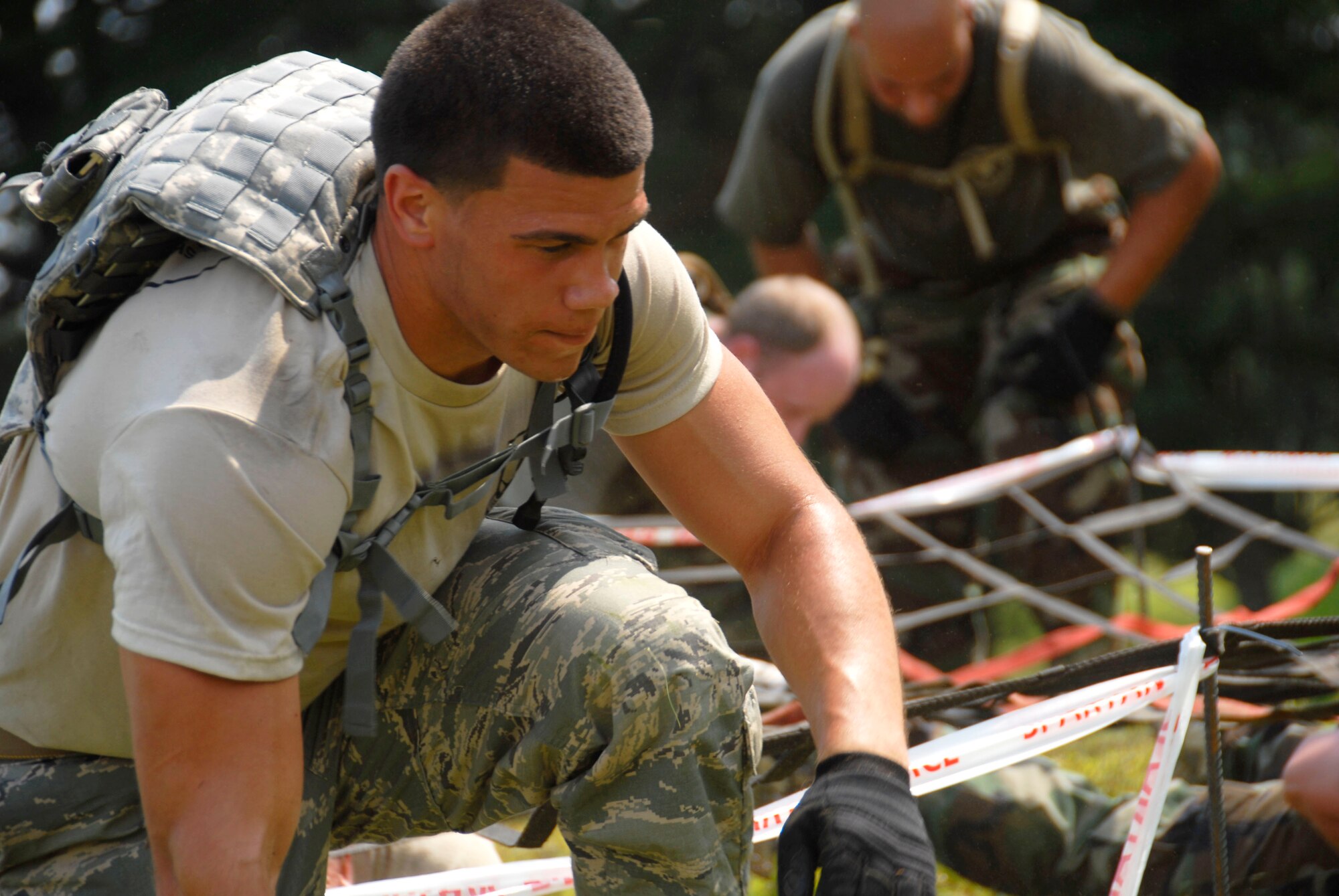 Senior Airman Joseph Rivera, assigned to the 103rd Secu-rity Forces Squadron, maneuvers his way through a ground crawl exercise at the Connecticut SWAT Challenge in West Harford, Conn., Aug. 23, 2012. The Air Guard team took top military team honors for the seventh straight year, fourth in the PT portion and 12th place overall in the annual competition. (U.S. Air Force photo by Senior Airman Jennifer Pierce/Released)