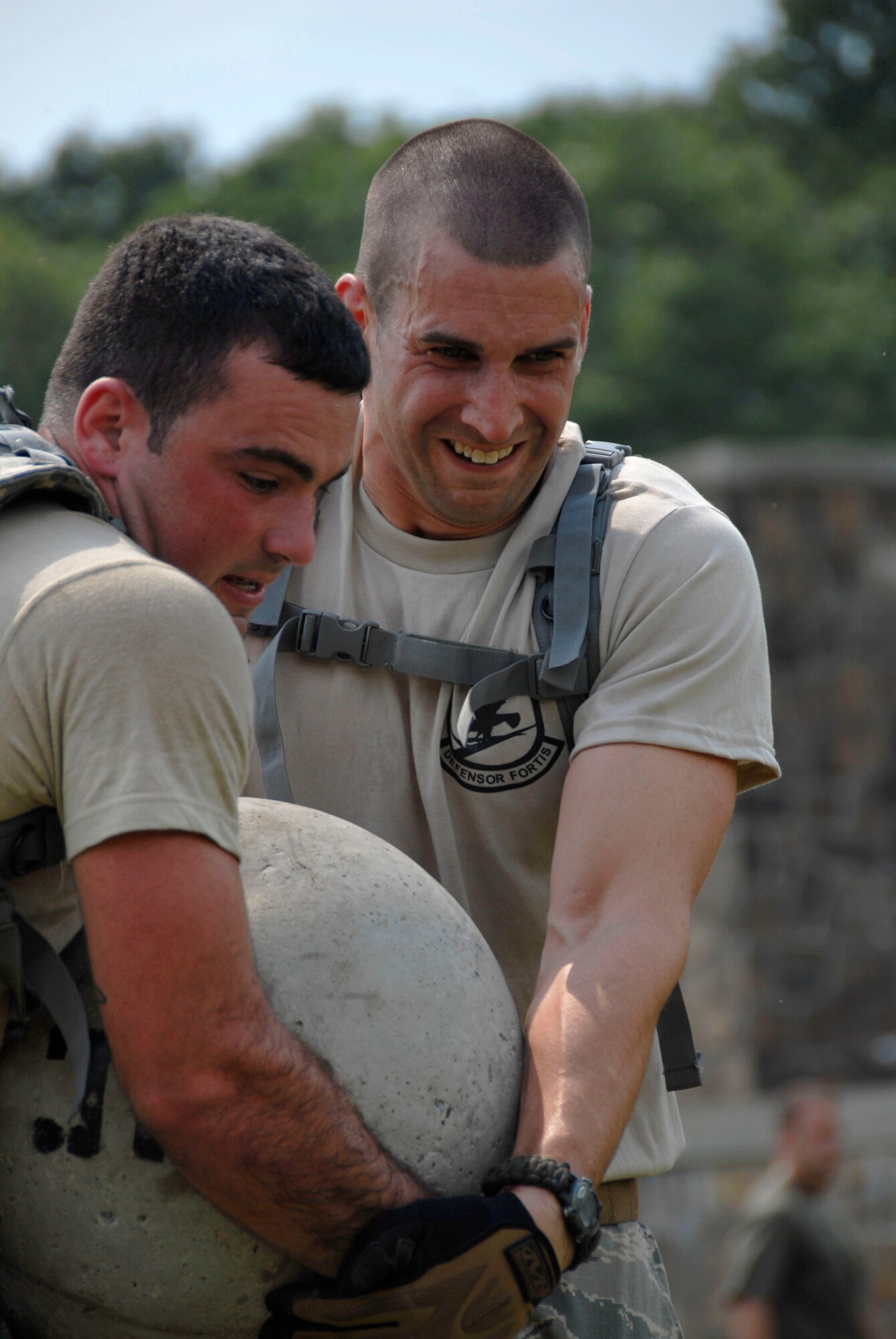 Airman 1st Class Francis Gelada and Staff Sgt. Christopher Sixt of the 103rd Security Forces Squadron assist each other carrying a weighted ball as part of the PT portion of the Connecticut SWAT Challenge in West Harford, Conn., Aug. 23, 2012. The Air Guard team took top military team honors for the seventh straight year, fourth in the PT portion and 12th place overall in the annual competition. (U.S. Air Force photo by Senior Airman Jennifer Pierce/Released)