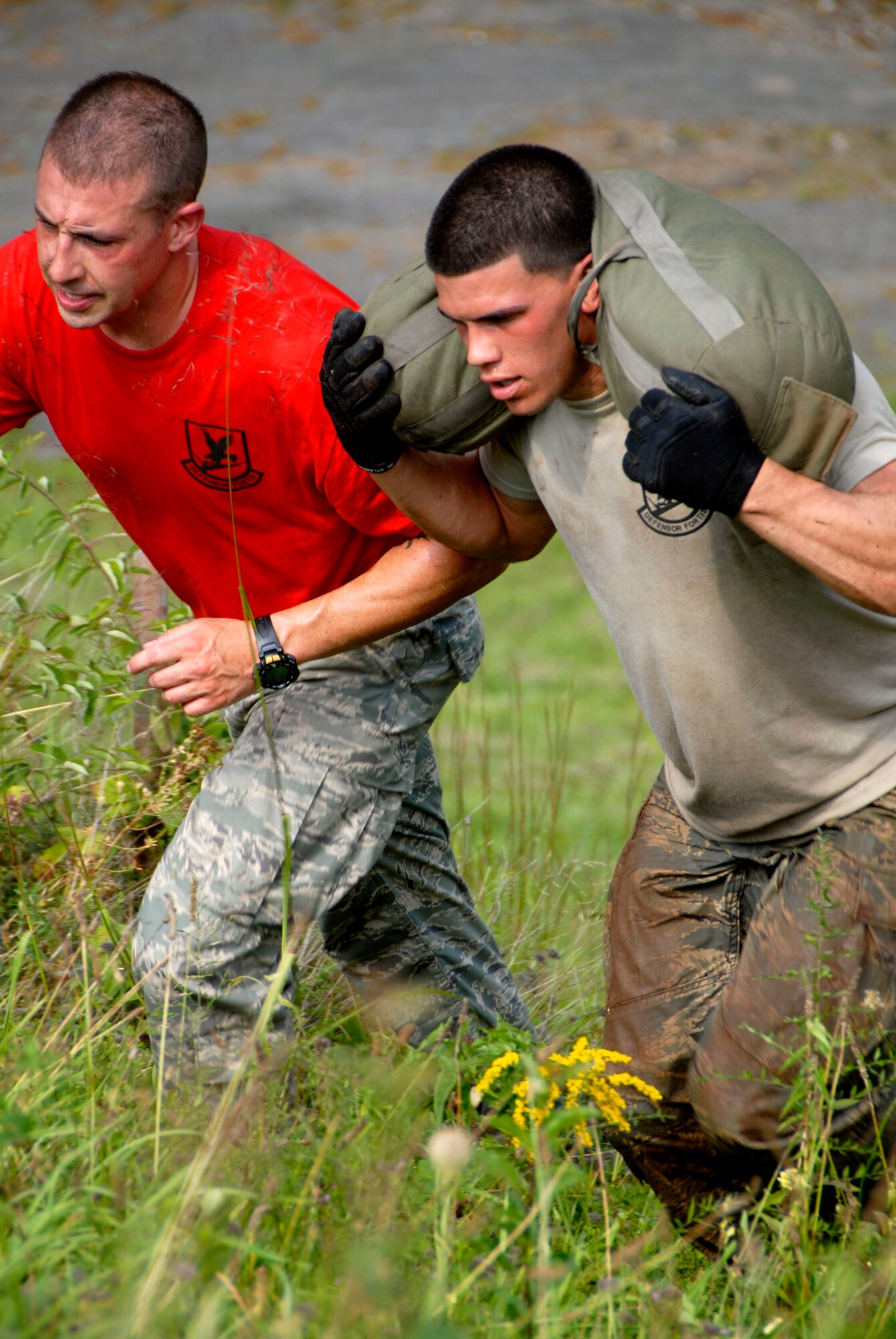 Senior Airman Joseph Rivera, assigned to the 103rd Security Forces Squadron, runs up a hill carrying a weighted bag. Rivera is participating in the PT portion of the Connecticut SWAT Challenge in West Harford, Conn., Aug. 23, 2012. (U.S. Air Force photo by Senior Airman Jennifer Pierce/Not Released)