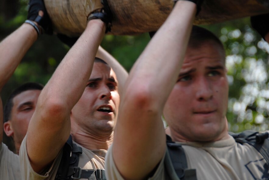 Members of the 103rd Security Forces Squadron hoist a log up during the PT portion of the Connecticut SWAT Challenge in West Harford, Conn., Aug. 23, 2012. (U.S. Air Force photo by Senior Airman Jennifer Pierce/Released)