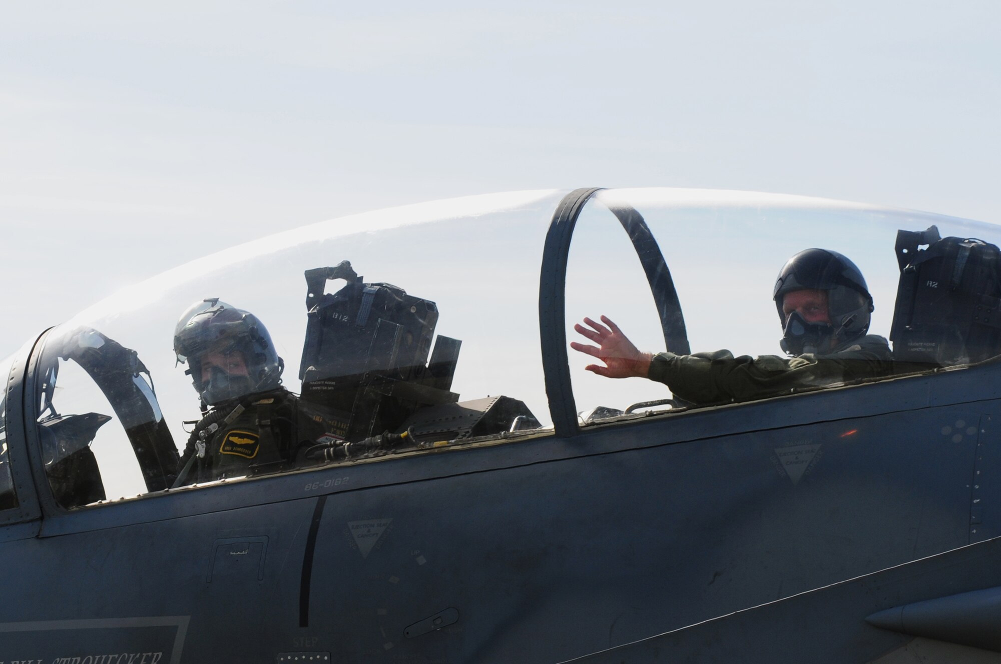 ROYAL AIR FORCE LAKENHEATH, England – John Cushing (right), 48th Fighter Wing honorary commander, waves goodbye while Capt. Gregory Schroeder, 493rd Fighter Squadron pilot, taxis an F-15D Eagle,  Sept. 6, 2012. Cushing received an incentive flight with the 493rd FS to receive a better understanding of how the 48th FW operates. Cushing is the chairman of the British-American Committee, which ensures the local relationship between American and British remains intact and encourages integration of the two communities. (U.S. Air Force photo by Airman 1st Class Cory D. Payne)