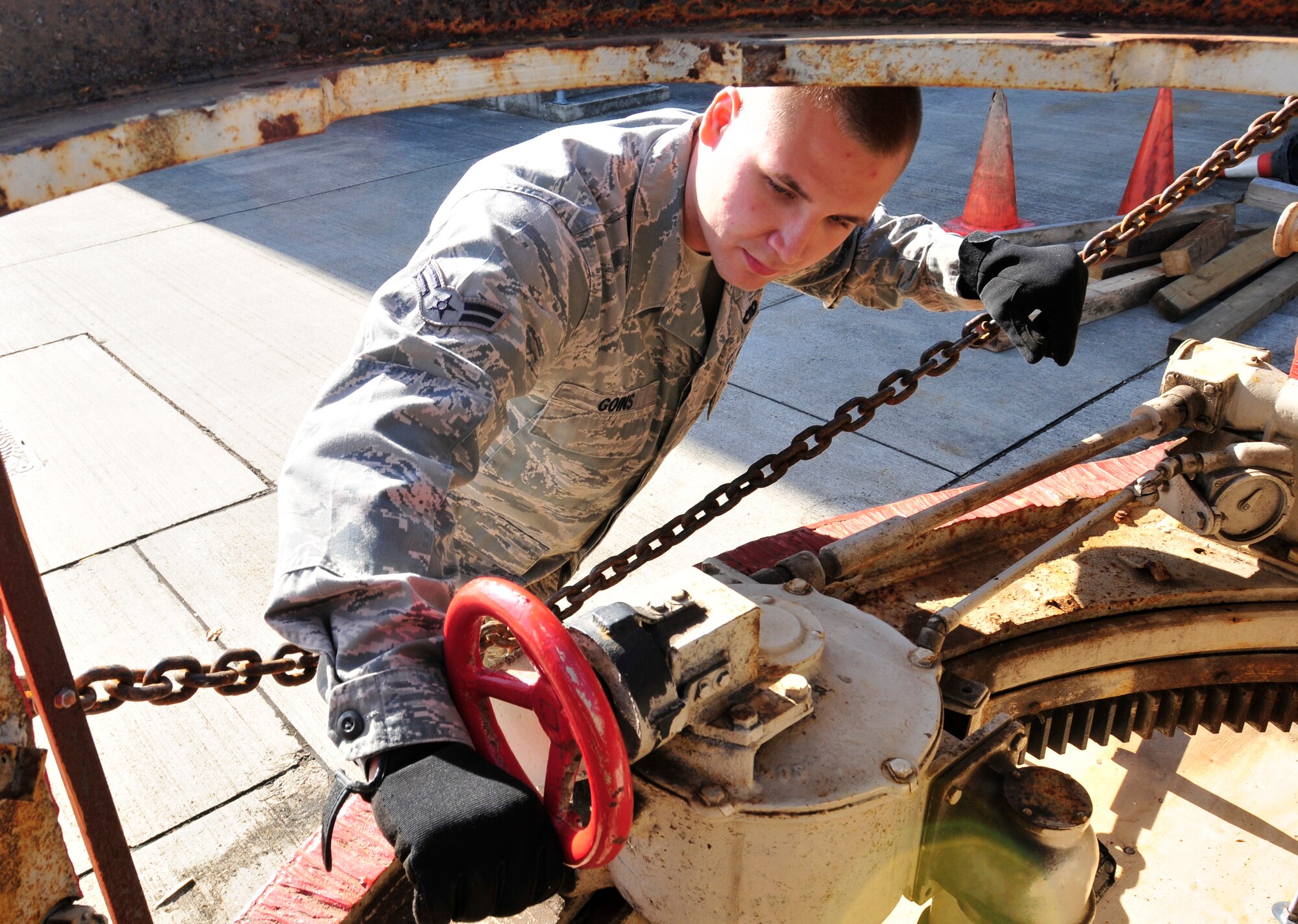ROYAL AIR FORCE LAKENHEATH, England - Airman 1st Class Heath Goins, 48th Logistics Readiness Squadron traffic management apprentice, performs a spot inspection on a World War II era Tiger 1 German tank Sept. 6, 2012. Goins was nominated for a Liberty Spotlight because he displays the core value of "Service before Self." (U.S. Air Force photo by Senior Airman Tiffany M. Grigg)