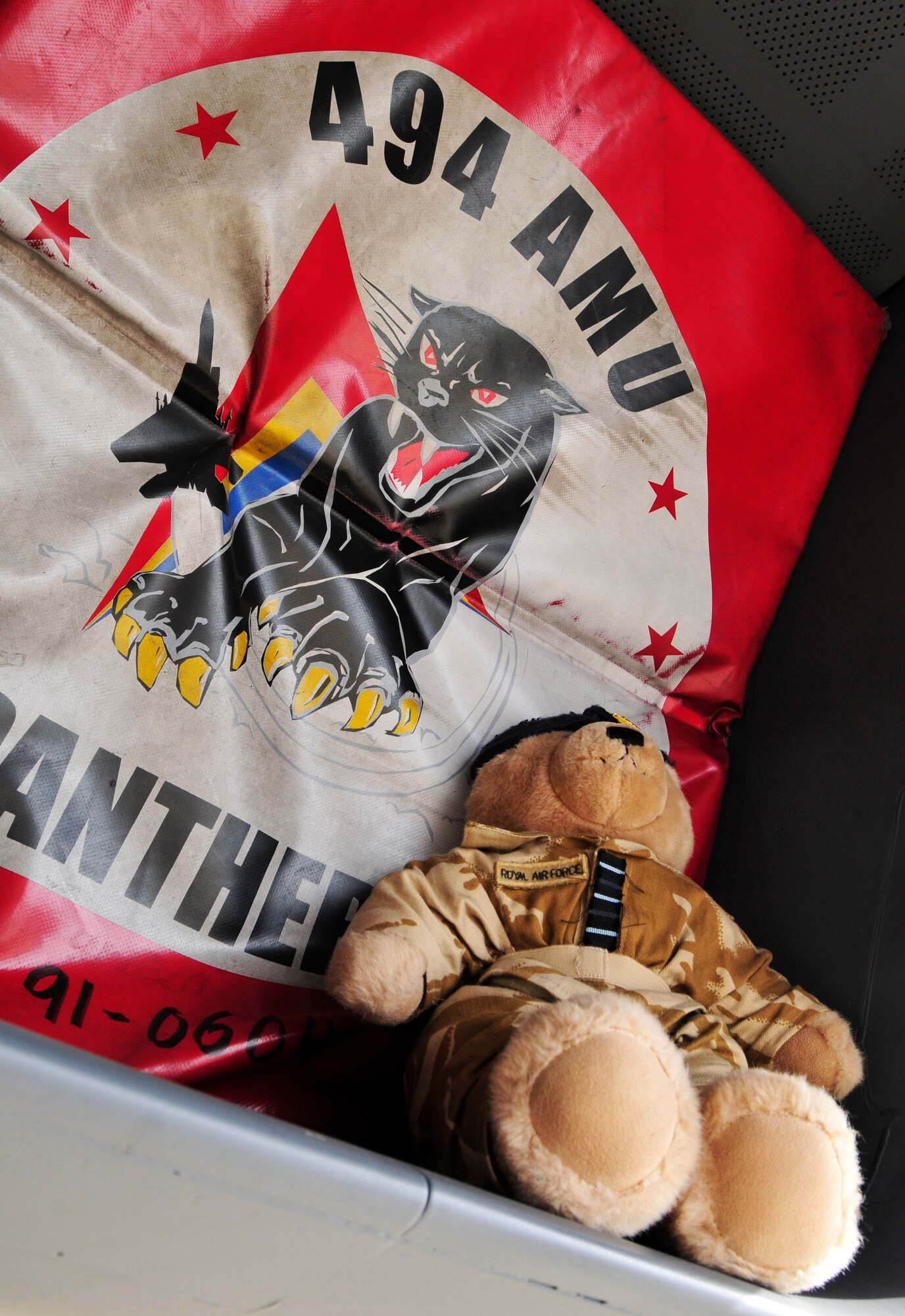 ROYAL AIR FORCE LAKENHEATH, England - Wing Commander Bear sits by the 494th Fighter Squadron panther emblem on an F-15 on the flightline Aug. 3, 2012. Bear has been visiting bases since his visit to Nellis Air Force Base, Nevada two years ago, where he flew with RAF 3 Squadron Harriers for two weeks. Bear will be auctioned off along with photos of all his visits for the Royal Air Force Valley charity in North Wales, the RAF Benevolent Fund and Medrwn Mon Anglesey charities. (U.S. Air Force photo by Senior Airman Tiffany M. Grigg) 