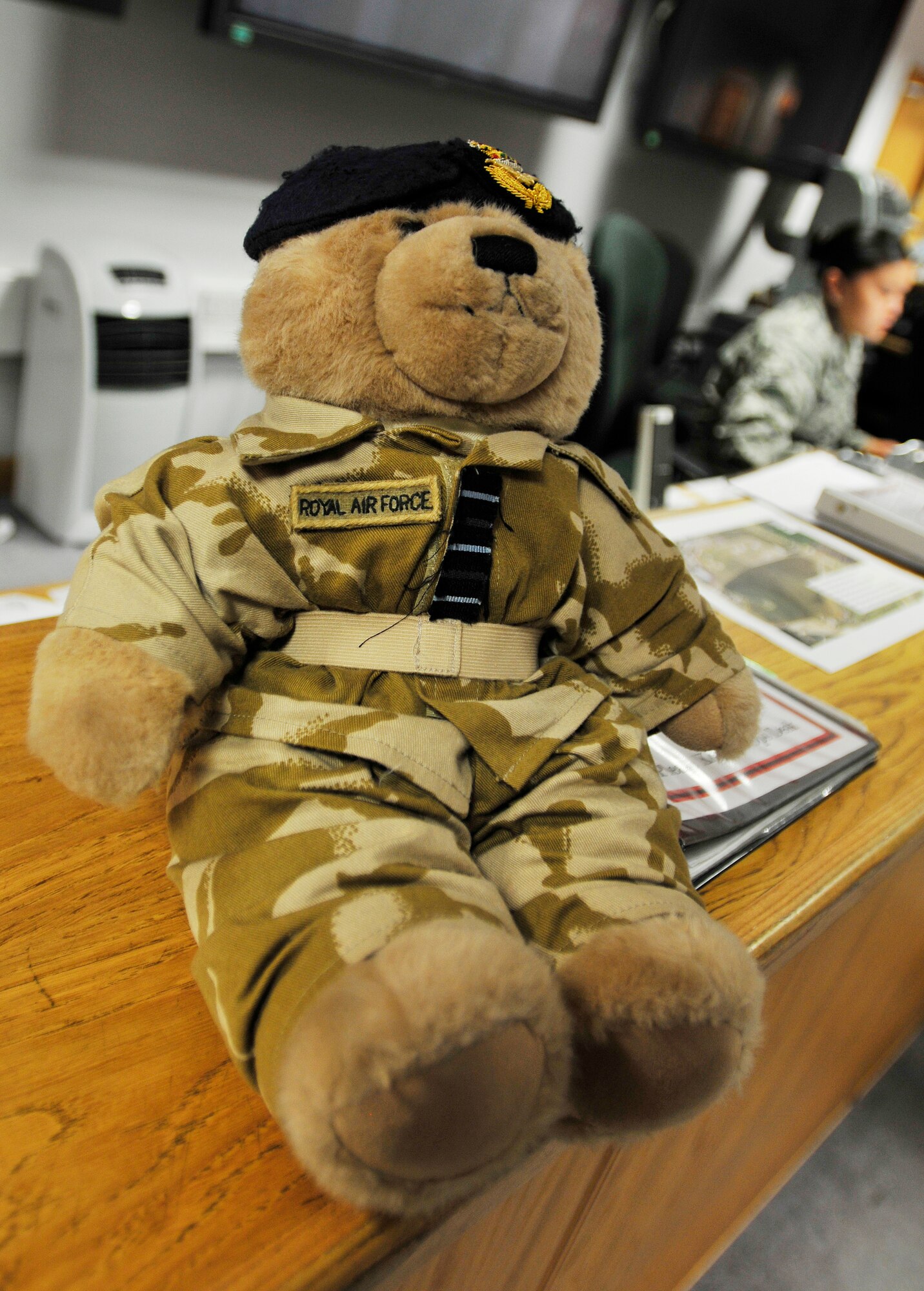 ROYAL AIR FORCE LAKENHEATH, England - Wing Commander Bear sits on the 494th Fighter Squadron Operations Desk at the Strike Eagle Complex Aug. 3, 2012. Bear has been visiting bases since his visit to Nellis Air Force Base, Nevada two years ago, where he flew with RAF 3 Squadron Harriers for two weeks. Bear will be auctioned off along with photos of all his visits for the Royal Air Force Valley charity in North Wales, the RAF Benevolent Fund and Medrwn Mon Anglesey charities. (U.S. Air Force photo by Senior Airman Tiffany M. Grigg) 