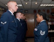 HANSCOM AIR FORCE BASE, Mass. – Airman 1st Class Nicholas Guarente stands at attention with other Airmen as Tech. Sgt. Mary Williams inspects their uniforms during a First Term Airman Class uniform inspection Aug. 27. In addition to the inspection, FTAC is designed to help transition the Air Force's first term airmen from a training environment to the operational Air Force and highlight their responsibilities as new airmen. (U.S. Air Force photo by Mark Herlihy)