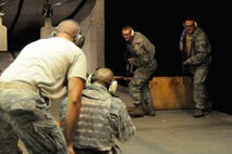 HANSCOM AIR FORCE BASE, Mass.--  (from left to right) Tech. Sgt. Scott Roy, Senior Master Sgt. Jamell Jenkins, Senior Airman Matthew Stretch and Tech. Sgt. Wayne Griggs participate in this month's security forces training. The training consisted of a Shoot Move and Communicate course, which standardizes basic individual and team firearms tactical skills necessary to engage hostile threats. (U.S. Air Force photo by Linda LaBonte Britt) 
