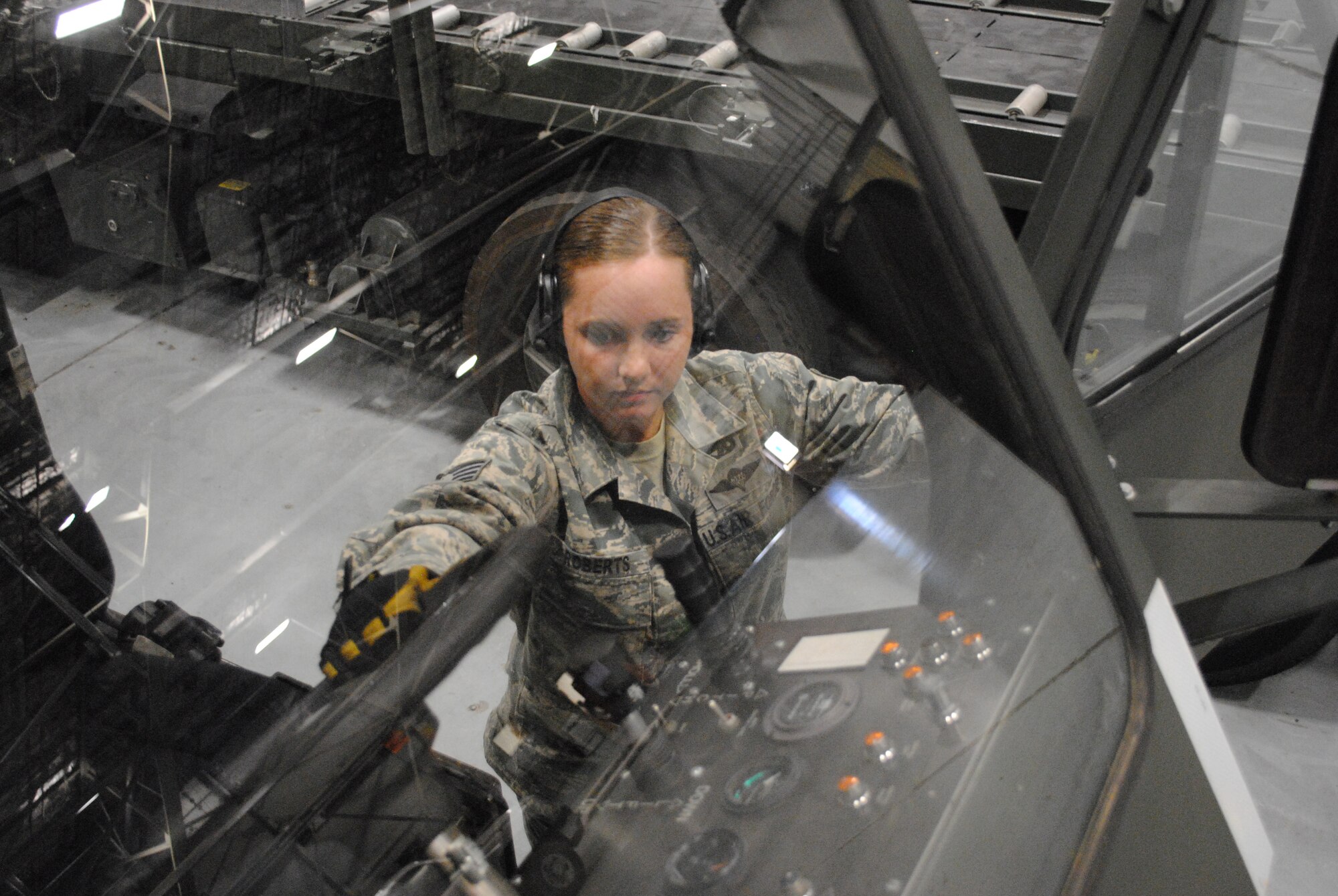 Staff Sgt. Chelsea Roberts, 319th Logistics Readiness Squadron, reaches for the steering wheel as she pulls herself up onto the driver seat of a Halvorsen k-loader used for transporting heavy cargo onto military aircraft, Sept. 5, 2012, at the terminal operation building on Grand Forks Air Force Base, N.D. Roberts helps manage material handling equipment valued at approximately $3 million. (U.S. Air Force photo/Senior Airman Luis Loza Gutierrez)