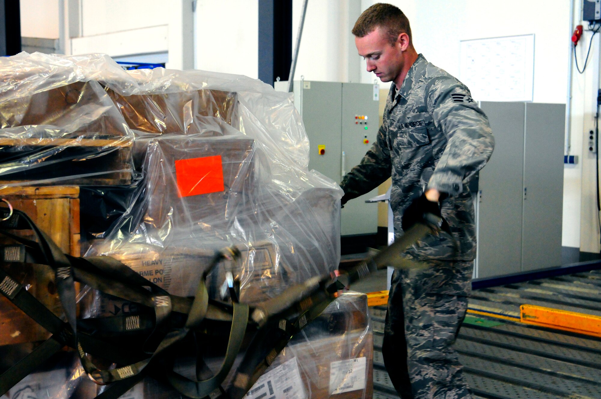 Senior Airman Bradley Stinson, 721st Aerial Port Squadron cargo processing specialist, unloads a shipment of cargo Aug. 22, 2012 on Ramstein Air Base, Germany. The 721st APS’s mission is to develop Airmen, provide air transportation services at Ramstein and sustain three combatant commands. 