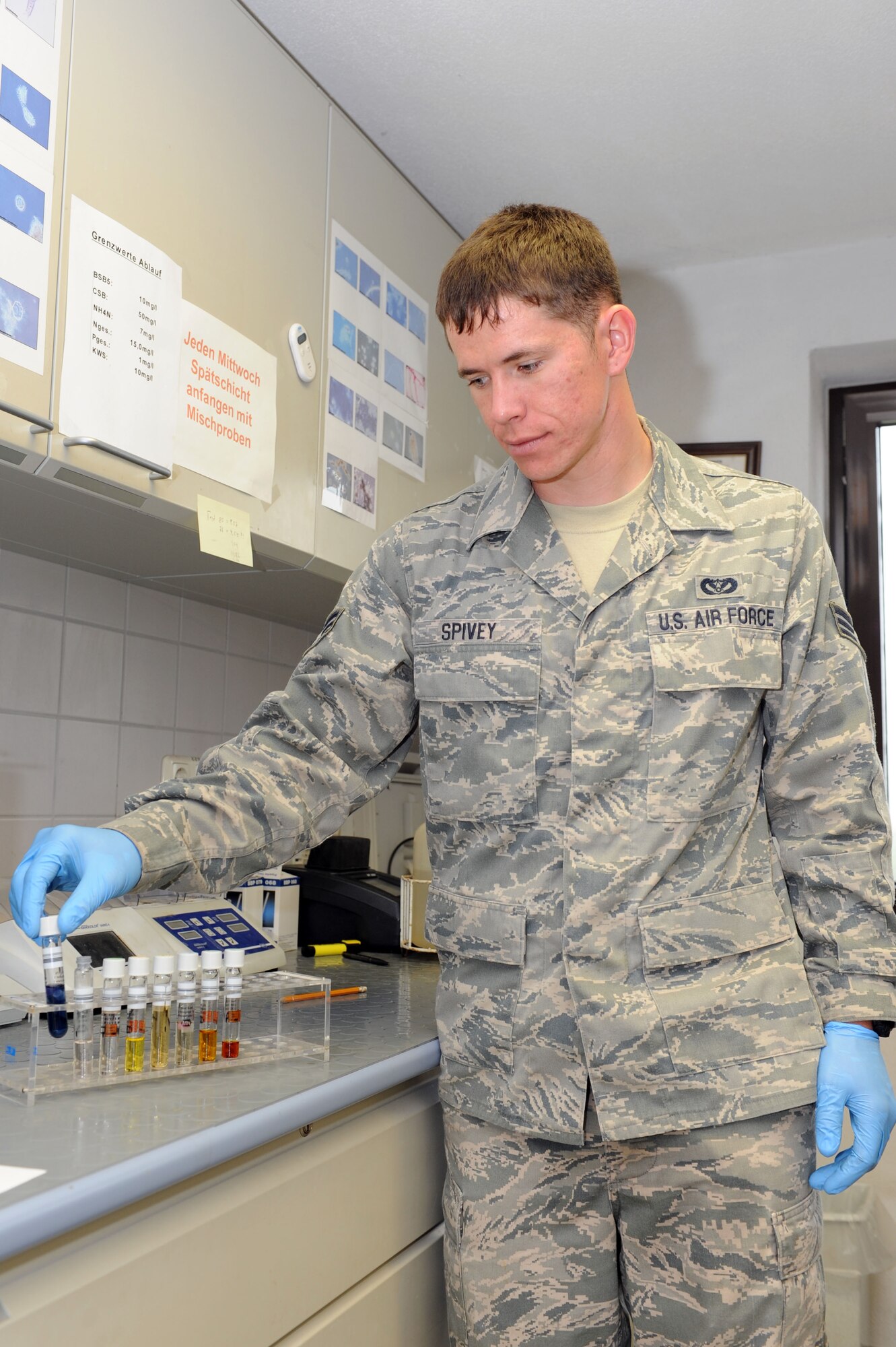 SPANGDAHLEM AIR BASE, Germany – Senior Airman David Spivey, 52nd Civil Engineer Squadron water and fuels system maintenance technician, places a water sample in a container at the wastewater treatment facility here Sept. 5. Samples are taken daily from every stage of the treatment process to ensure they meet German environmental standards. The facility processes wastewater from the base to remove any hazardous chemicals it may contain before it is released back into the environment. (U.S. Air Force photo by Senior Airman Christopher Toon/Released)