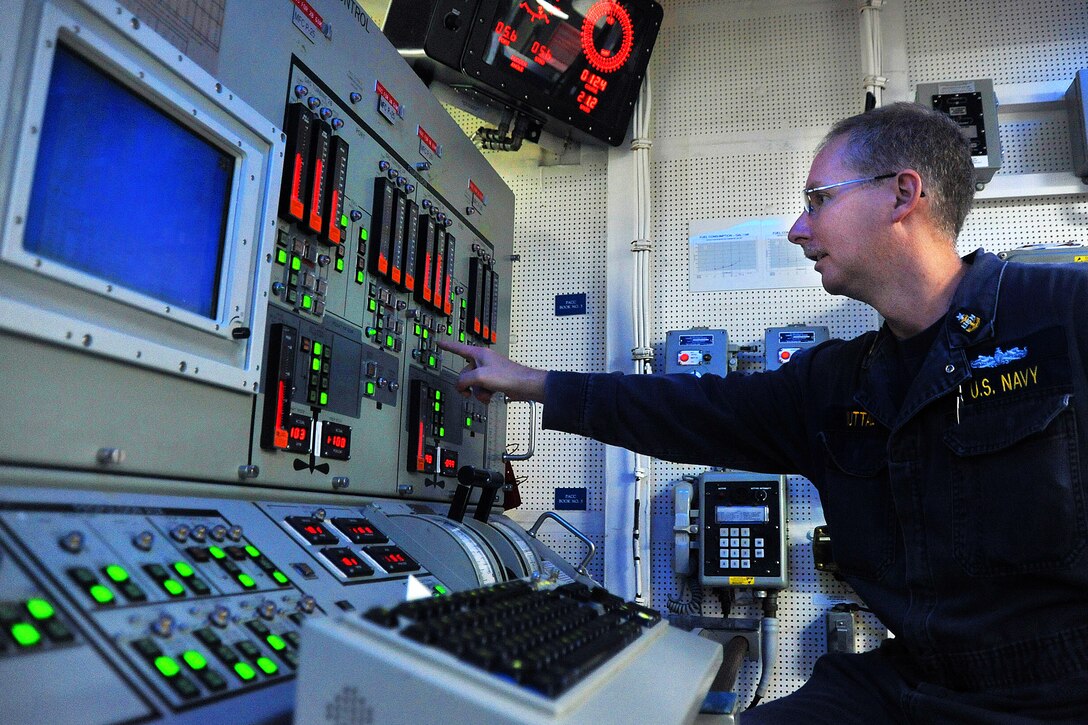 U.S. Navy Senior Chief Arthur Nuttal operates the propulsion auxiliary control console in the central control station of the guided-missile destroyer USS  McCampbell in the Pacific Ocean, Sept. 3, 2012. Nutal is a gas turbine system technician.