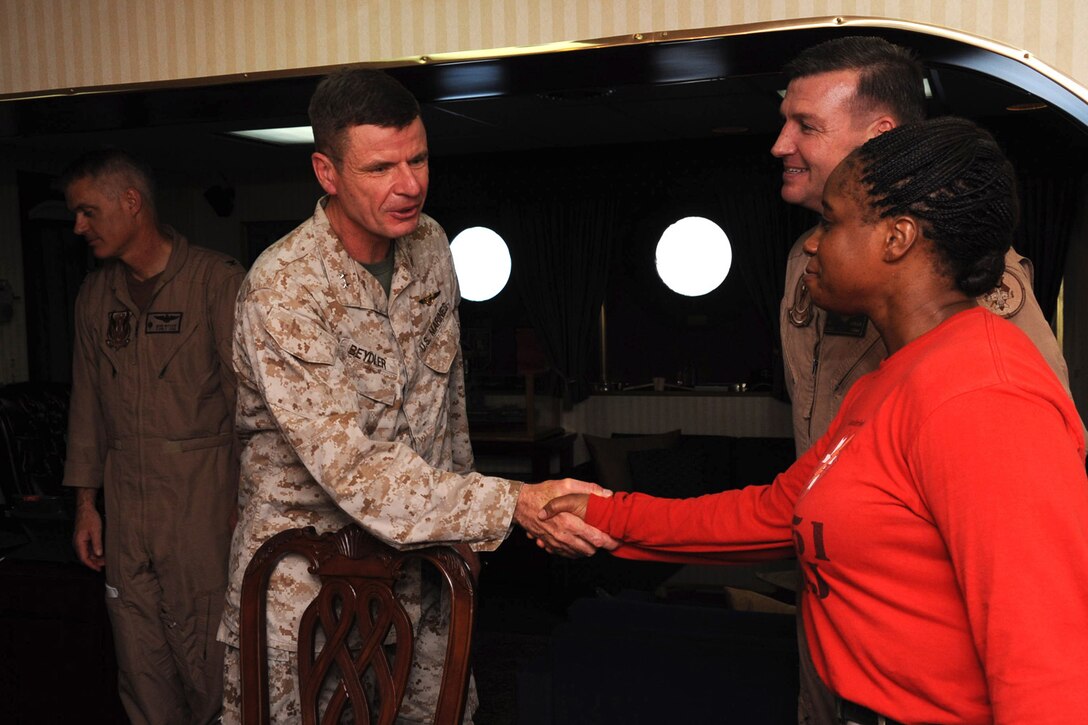 Major General William Beydler, U.S. Central Command J-5, director, strategy, plans and policy,  shakes hands with Sgt. Maj. Leveta Smith, Marine Fighter Attack Squadron 251 sergeant major, during his initial meeting with the squadron’s commanding officer and sergeant major, Aug. 19. The squadron also met British Royal Marines as they came aboard USS Enterprise during their deployment.