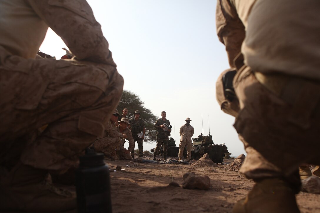 Marines with the 24th Marine Expeditionary Unit's Light Armored Reconnaissance platoon, Battalion Landing Team 1st Battalion, 2nd Marine Regiment, conduct an orders briefs with their French counterparts in preparation for a bilateral training raid with French Marines in Djibouti, Aug. 27, 2012. A small contingent of the 24th MEU is currently ashore in Djibouti conducting various unilateral, bilateral and joint exercises. The 24th MEU is deployed with the Iwo Jima Amphibious Ready Group as a theater reserve and crisis response force throughout the U.S. Central Command and U.S. 5th Fleet area of responsibility.